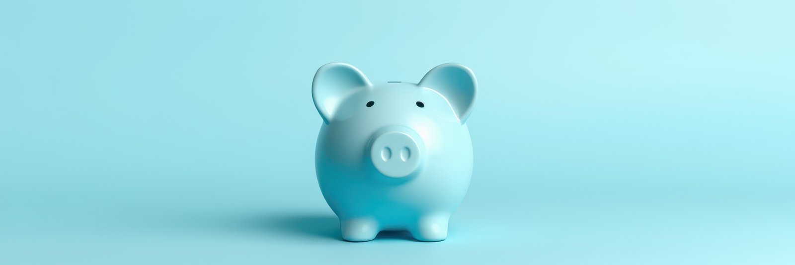 Cute blue piggy bank stands on a light blue background, inviting savings and financial planning